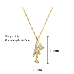 Macro view of gold teddy bear pendant showing dimensions 3.4cm by 1.6cm and chain length