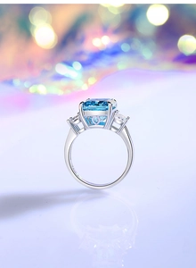 Macro shot of emerald-cut aquamarine high carbon diamond ring on S925 silver band