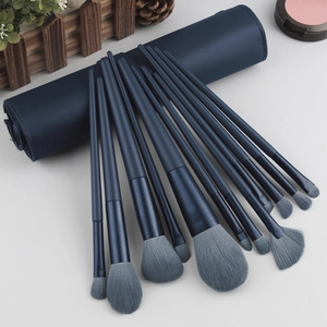 Detail of 13pcs soft navy makeup brushes with a premium PU leather travel pouch