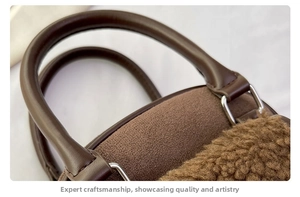 Detail of brown plush tote with suede texture and leather handle on metal rings