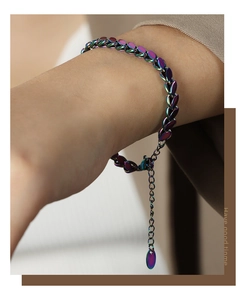 Macro view of rainbow titanium steel oval link bracelet with adjustable teardrop pendant
