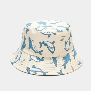 Beige reversible bucket hat featuring blue cartoon shark prints and DAEIL text