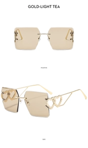 Detail of square rimless sunglasses with gold heart hinge and light tea lenses