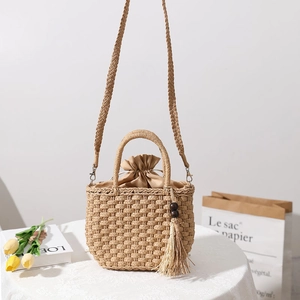Handmade straw bag with wooden bead tassels and drawstring lining for beach vacation