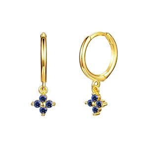 Detailed close-up of gold hoop earrings featuring elegant blue four-petal floral pendants