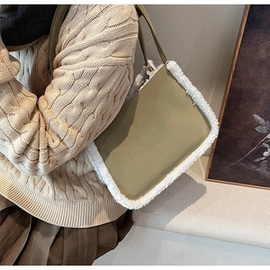 Detailed texture of olive green suede tote bag with white faux shearling trim details