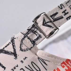 Macro detail of graffiti baseball cap with silver metal buckle and adjustable canvas strap
