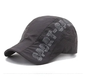 Detail view of dark grey quick-dry sport cap with laser-cut holes and SPORT print
