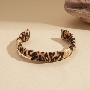 Detailed view of leopard print faux leather texture on a stylish wrap bracelet