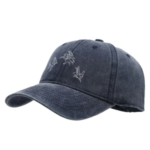 Vintage washed blue baseball cap with white bird embroidery and six-panel structure