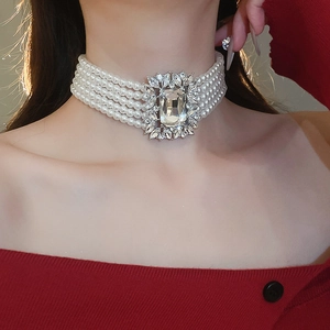 Close-up of a luxurious 5-layer pearl choker with a central crystal rhinestone pendant