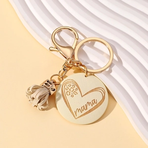 Detail of mama wooden keychain with leopard print heart and cream leather tassel