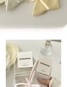 Macro view of combed cotton crew socks with soft ribbons and branded packaging detail