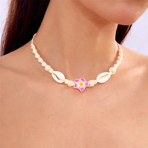 Detail of adjustable woven necklace with white seashells and Frangipani flowers for summer