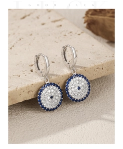 Detailed macro view of S925 sterling silver blue evil eye drop earrings with fine stones