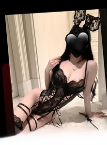 Detailed view of black lace and faux leather lingerie set with bunny ears and stockings
