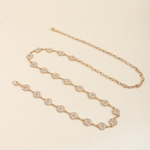 Close-up of golden metal waist chain with sparkling rhinestones and adjustable lobster clasp