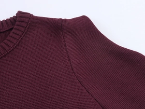 Close-up of crew neck stitching and fine burgundy knit texture on short top