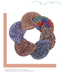 Detailed close-up showing various colors of leopard print pleated turbans and headwraps