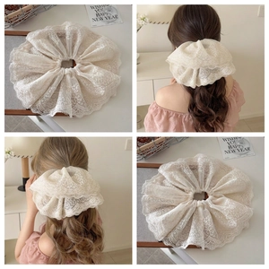 Elegant white lace scrunchie with floral embroidery for messy bun or ponytail