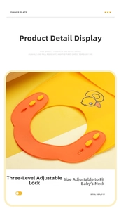 Detail of adjustable 3-button closure on a soft silicone baby bib with duck pattern