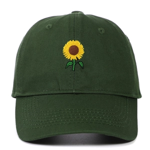 Detailed close-up of yellow sunflower embroidery on dark green twill cotton baseball cap