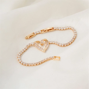 Elegant gold-plated heart tennis bracelet with sparkling zircon crystals on white silk