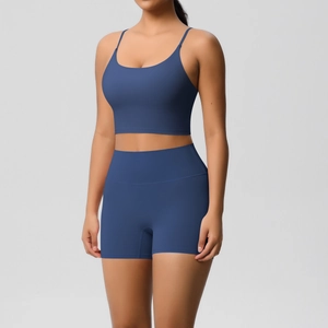 Detail of high-waist navy yoga shorts and thin strap sports bra set in matte fabric