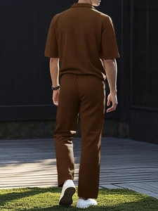 Close-up of brown textured short-sleeved shirt and trousers with vertical fabric detail