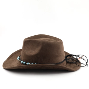 Detail of a brown suede cowboy hat featuring turquoise beads and metallic studs