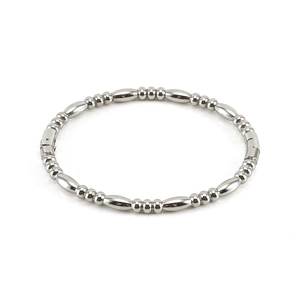 Detailed view of silver stainless steel bracelet featuring conical beads and polished surface