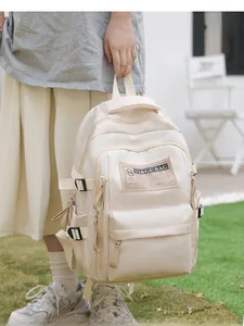 Close-up of cream large capacity nylon backpack with brand label and multi-layer zippers