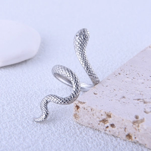 Adjustable stainless steel snake ring with detailed silver scales on stone display