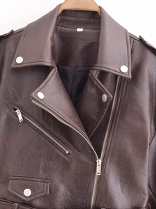 Detail of brown PU leather jacket featuring metallic zipper and collar texture on a hanger