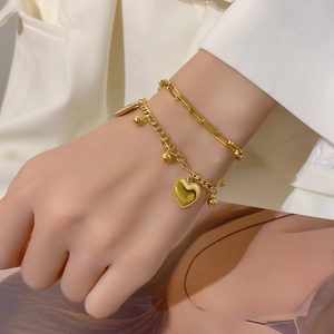 Double-layered gold heart bracelet set with paperclip chain and polished beads for women