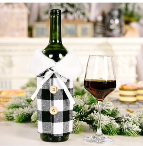 Close-up of a festive black and white buffalo check wine bottle cover with faux fur collar
