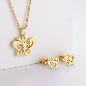 Macro detail of a gold butterfly jewelry set with a polished necklace and stud earrings