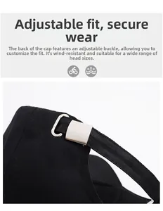 Detail of adjustable metal buckle and black fabric strap on a cotton baseball cap