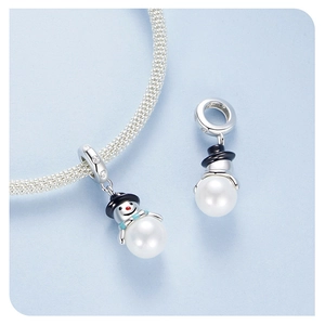 Macro detail of snowman charm bead in S925 sterling silver with pearl for DIY bracelets