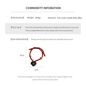 Detailed macro view of heart pendant featuring resin and wood with red woven cord