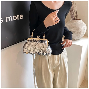 Detail of silver sequin evening clutch bag with golden chain and retro ball clasp