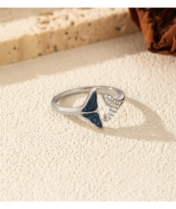 Macro shot of S925 sterling silver mermaid tail ring with blue and white crystals