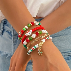 Detailed close-up of 5-piece Christmas beaded bracelet set with festive charms on wrist
