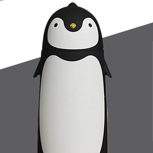 Close-up of cute penguin thermos bottle with matte finish and yellow beak details