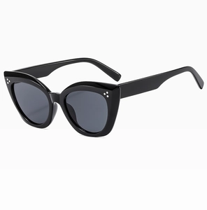 Cat-eye sunglasses with black frame and three-dot metal rivets from a 45-degree angle