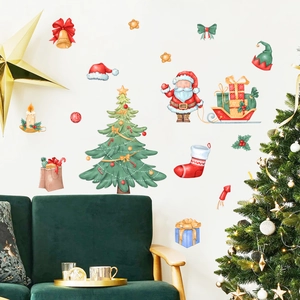 Detail showing watercolor Santa Claus and Christmas tree wall stickers on a white wall