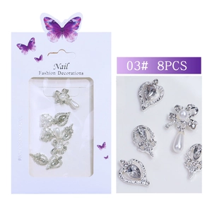 Macro view of silver alloy nail charms set with pearls and rhinestones 8pcs