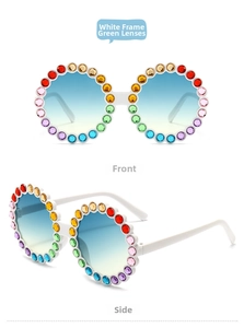 Detailed view of white round sunglasses with colorful rhinestones and gradient lenses