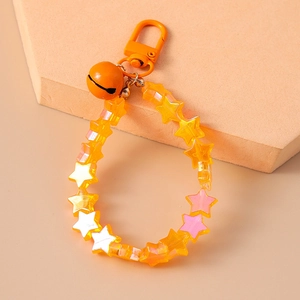 Detail of yellow star beads and orange bell pendant on a durable metal keychain