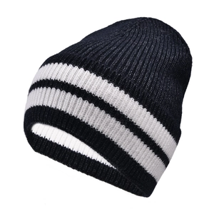 Close-up of thick striped knit texture on black and white wool winter beanie cap